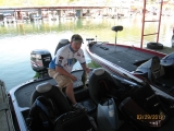 TBF of Michigan co-angler Matt Gray digs a spotted bass from the livewell