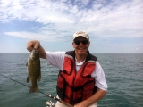 Rep. Tim Kelly shows off a Lake St. Clair smallmouth bass he caught while fishing with Dave Reault