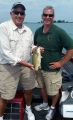Senator Ken Horn shows a smallmouth bass he caught along with his other boat partner MDNR fisheries biologist Tom Goniea