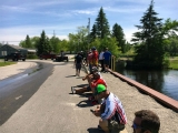 The Bass Federation of Michigan 2018 State Championship anglers and spectators watch the weigh-in at the FLW trailer