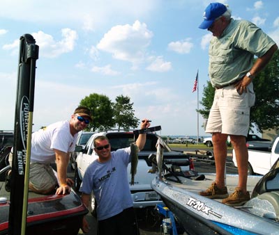 Bill Simpson smiles as his smallmouth bass just tips the balance beam in his favor to break the 12th place TBF of Michigan State Team tie with Bob Evans